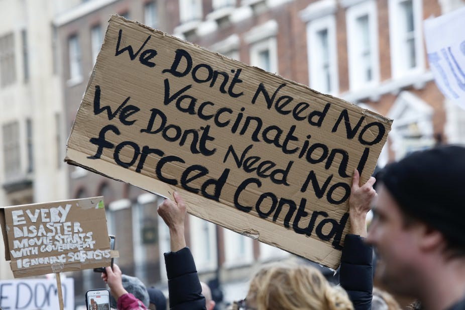 Protest sign: We don't need no vaccination! We don't need no forced control
